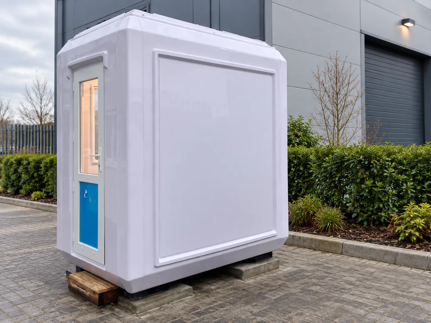 GRP security hut with blue door in a car park