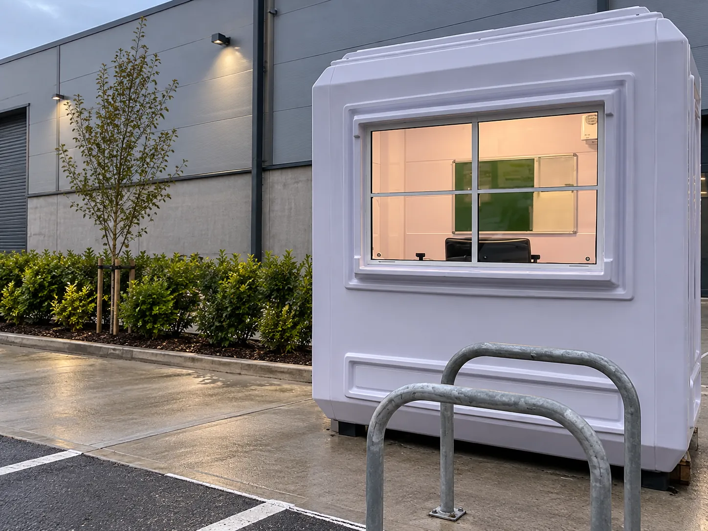 GRP hut with sliding window beside a building